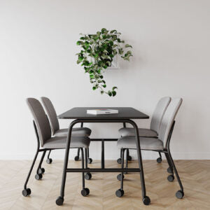 Lifestyle image of grey Bejot Hens chairs around a round black table with hanging plant