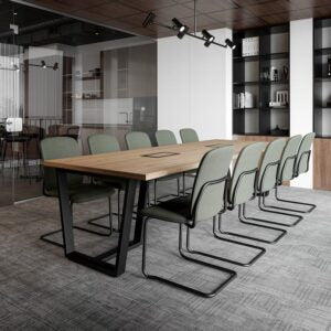 Lifestyle image of green Bejot Hens cantilever chairs at a long wooden meeting table