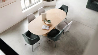 Lifestyle image of green and grey Mobitec Saga chairs at an oval table, top view