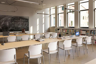 Lifestyle image of white Bejot Volo chairs at long tables in a library