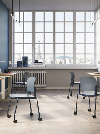 Lifestyle image of grey Bejot Volo chairs at desks by factory windows
