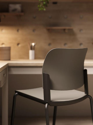 Lifestyle image of a green Bejot Volo chair in a wooden interior