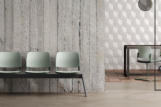 Lifestyle image of a mint green Bejot Volo three-seat waiting bench against a concrete wall